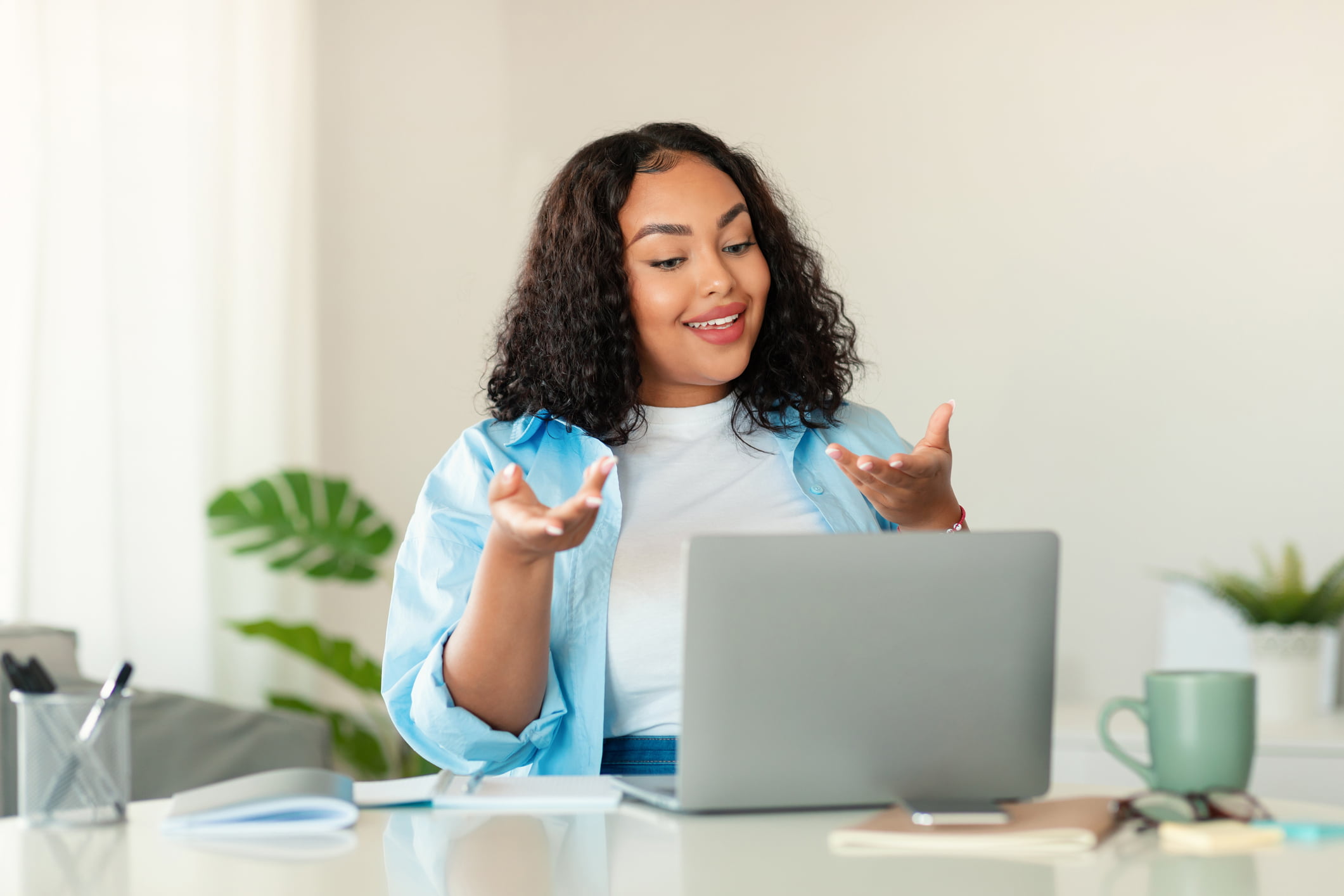 black woman smiling, doing a mental health assessment on her laptop