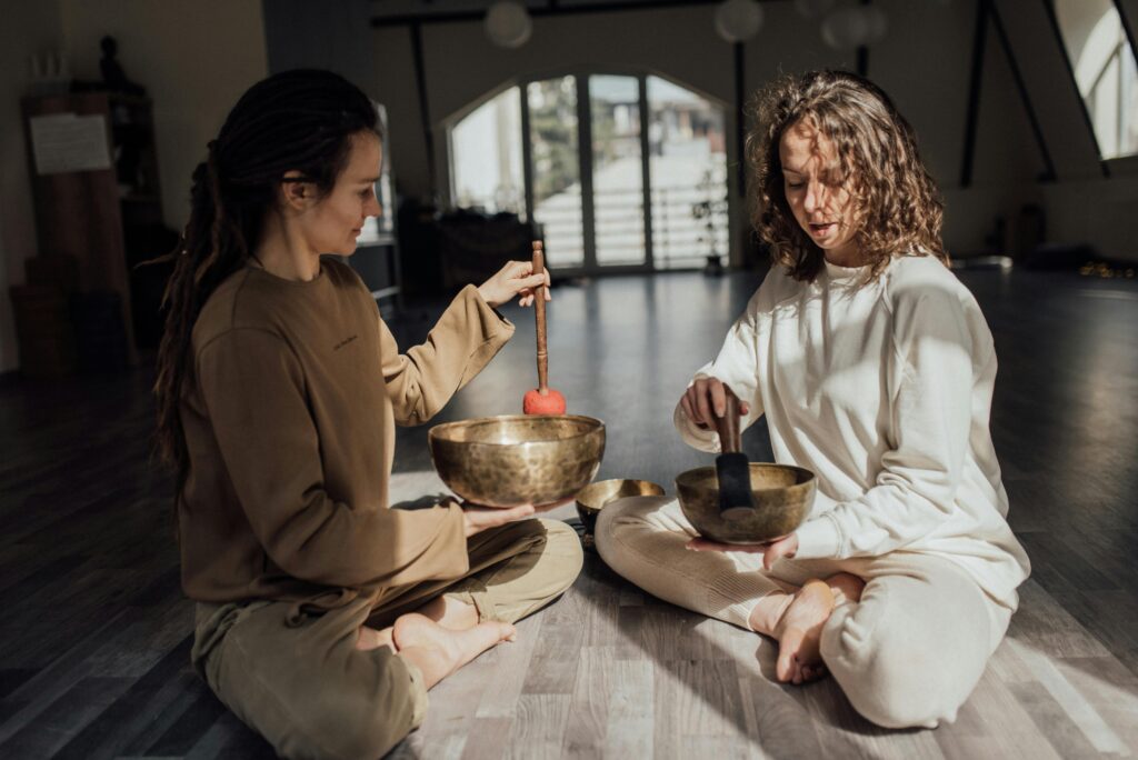 Sound Healing - two women playing sound bowls